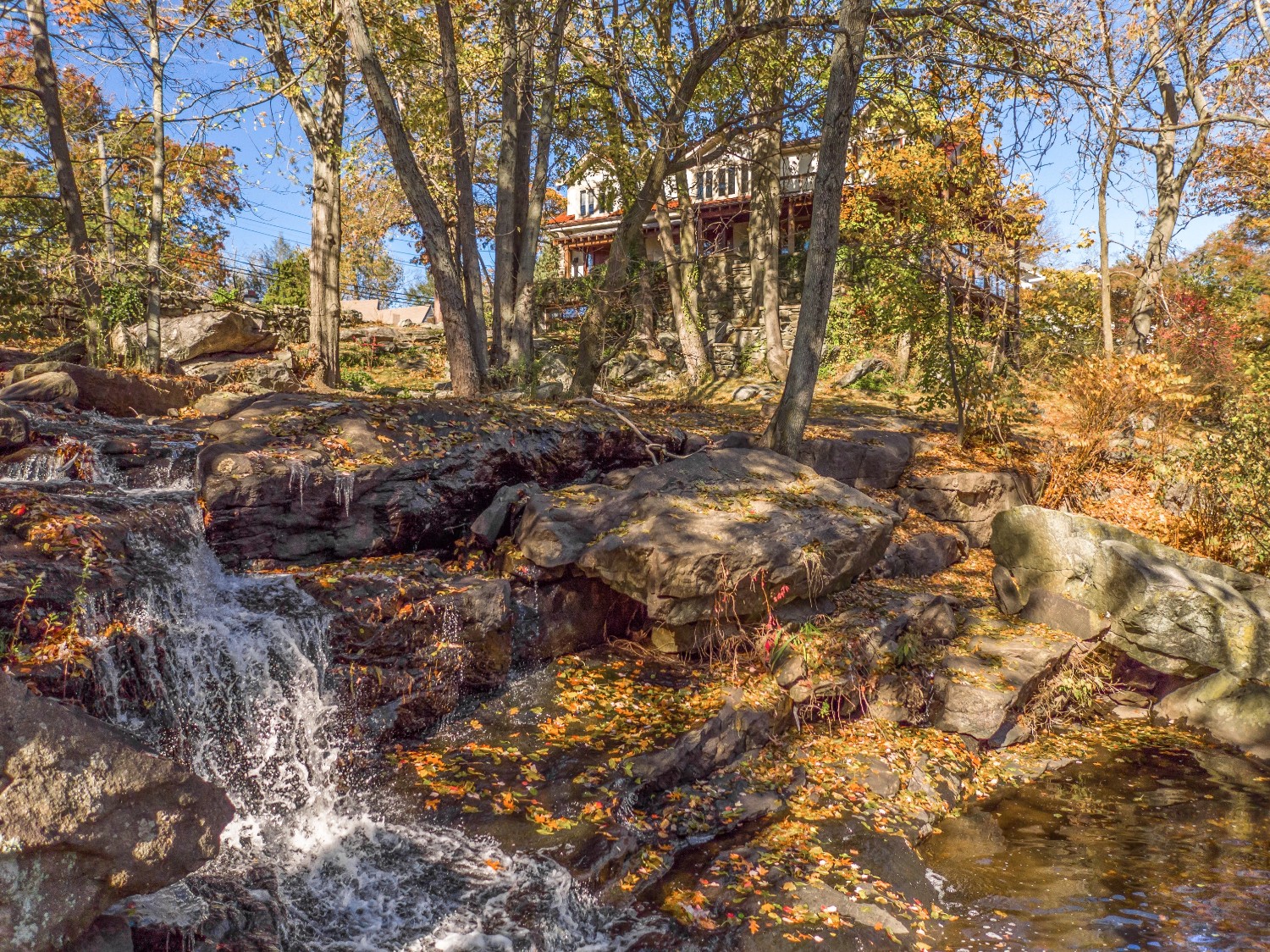This $2.55M Westchester home has Arts & Crafts interiors and its own waterfall